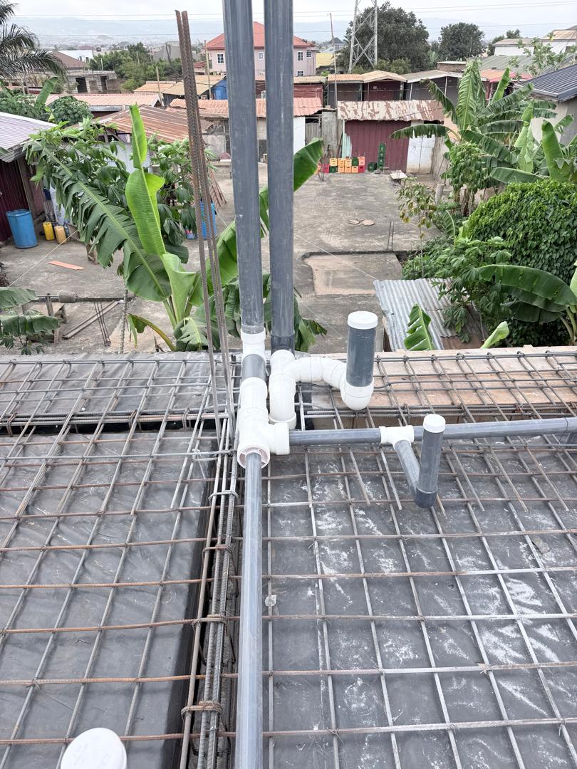 PVC waste pipes installed on reinforcement mesh before concrete slab casting