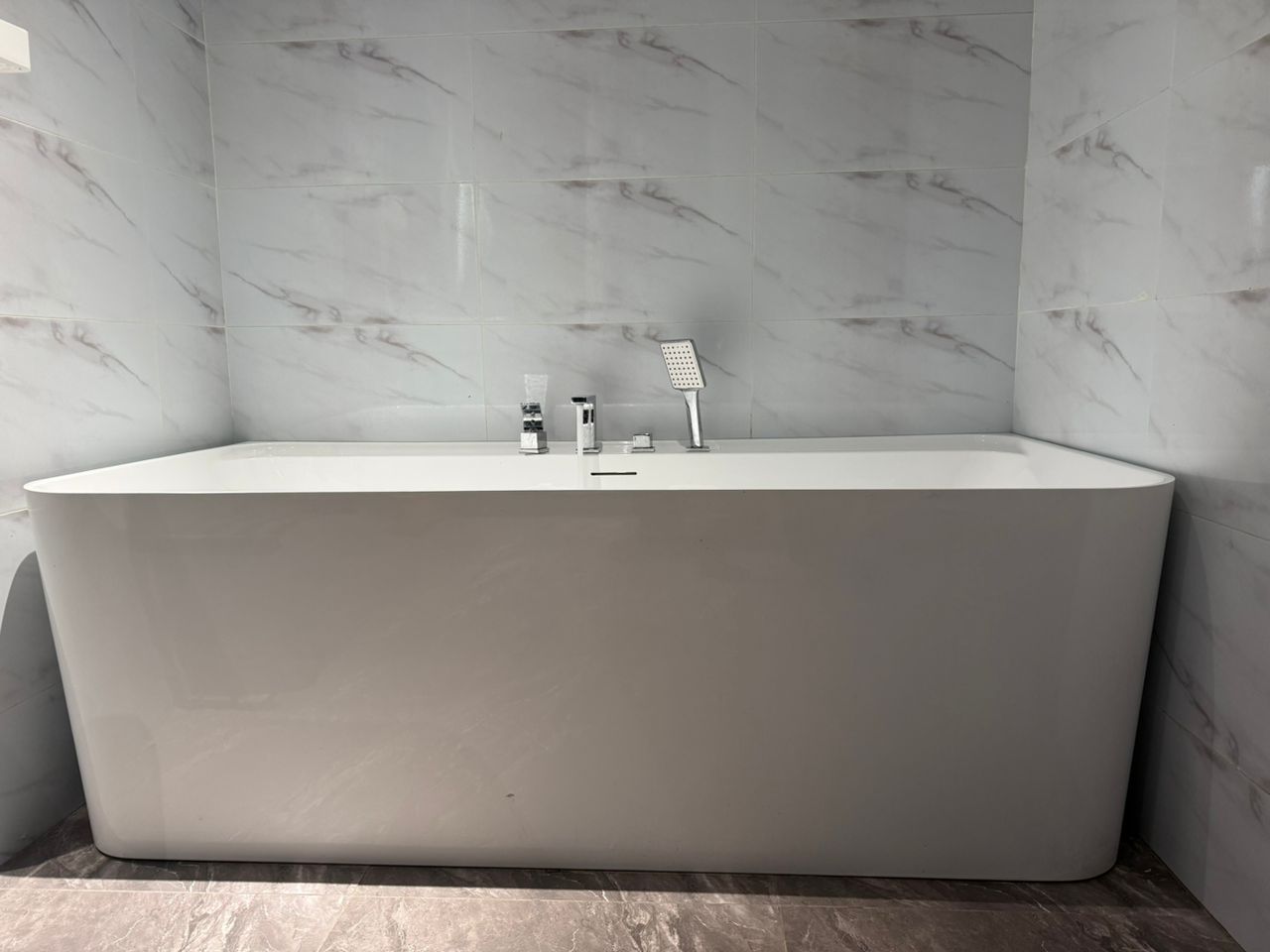 Freestanding bathtub installation by Holiness Plumbing & Construction